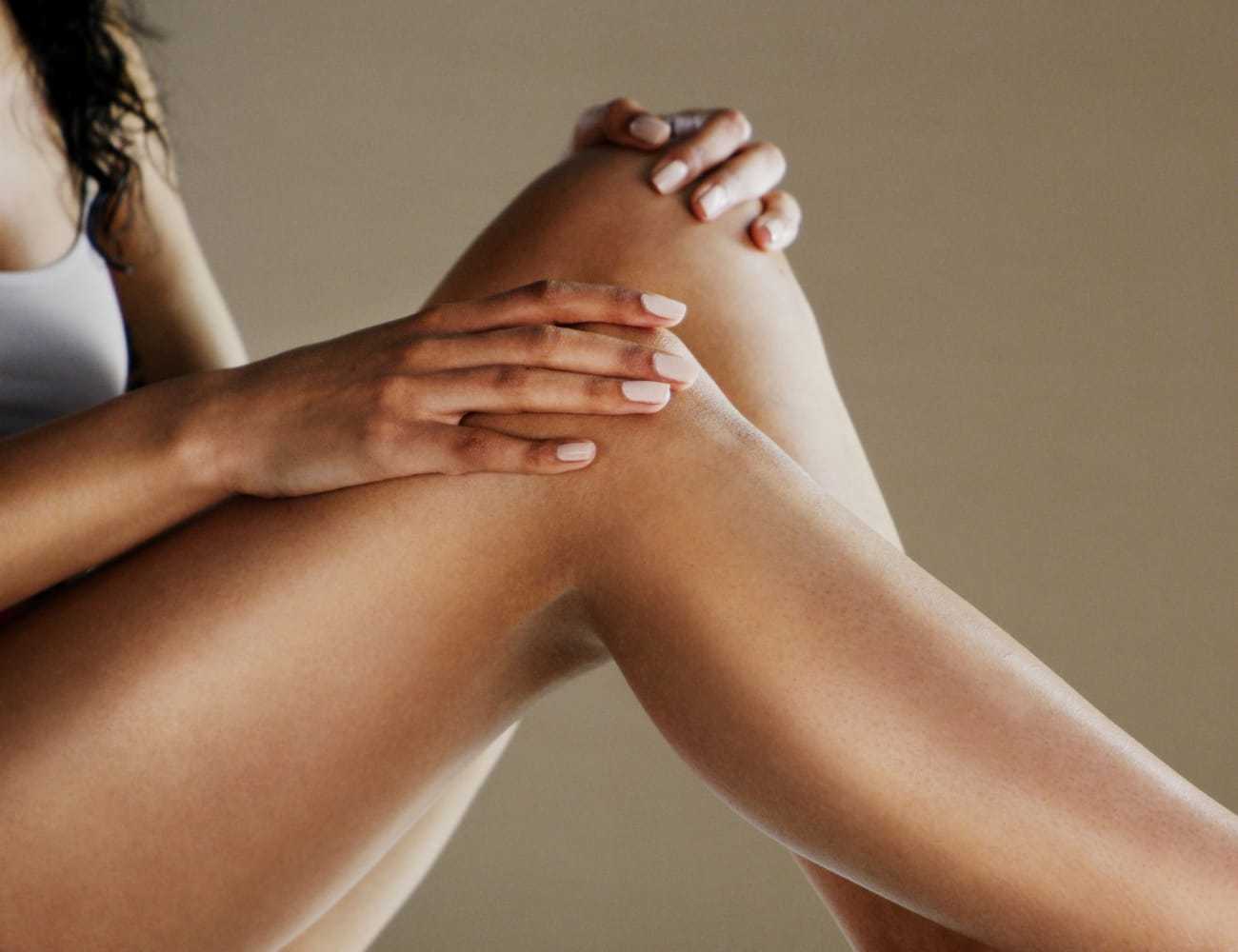 Smooth legs and hands with manicured nails, showcasing skin care and relaxation.
